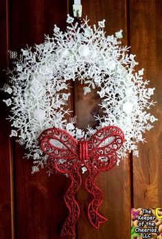 a red and white wreath with snowflakes on it