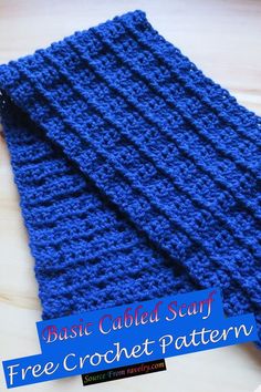 a blue crocheted scarf sitting on top of a wooden table with the text basic cabled scarf free crochet pattern