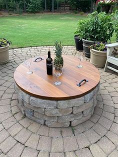 a wooden table sitting on top of a brick patio