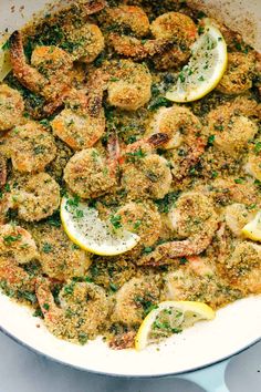 a skillet filled with shrimp and lemon slices