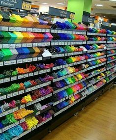 there is a display in the store with lots of different colored beads on it's shelves