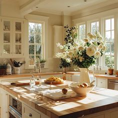 a kitchen counter with flowers in a vase on it