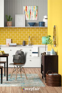 a room with yellow walls and white furniture in the center is a dining table, two chairs, an area rug, and a painting on the wall