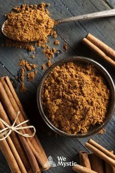 cinnamon powder and cinnamon sticks on a wooden table