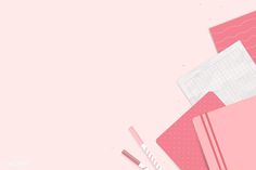 a pink background with various stationery items on it