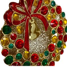 This is a really festive brooch. Studded with multicolored rhinestones and a cute little bell that rings. It is made with round chaton cut rhinestones in Ruby, Emerald & Topaz all set in a gold-tone metal base. Please not that the center is see through where the bell hangs, picture does not display that clearly. Dates to the 1960s and in great condition. Christmas Festive Jewelry With Rhinestones, Holiday Rhinestone Jewelry Gift, Holiday Rhinestone Jewelry For Gifts, Festive Holiday Jewelry With Rhinestones, Holiday Jewelry Gift With Rhinestones, Holiday Gift Jewelry With Rhinestones, Aries Necklace, Vintage Wreath, Ram Photos