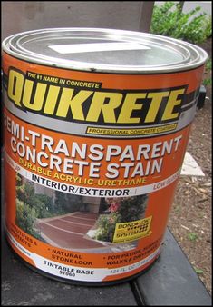 an orange paint can sitting on top of a bench