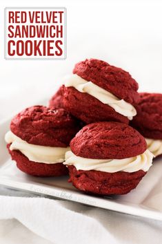 red velvet sandwich cookies with cream frosting on a plate