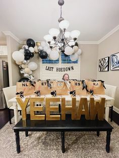 a table topped with bags and balloons in the shape of letters