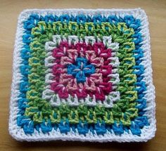 a crocheted square is sitting on a table