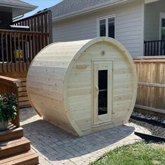 a small wooden building sitting in the middle of a yard