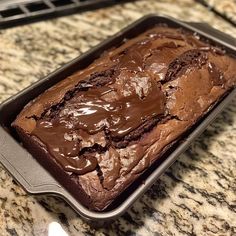 a loaf of chocolate cake sitting on top of a counter