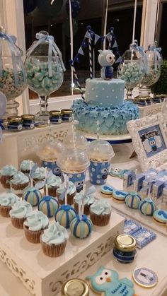 a table topped with lots of cupcakes and cakes