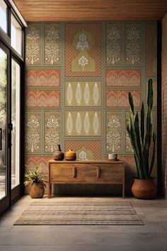 a living room with a large cactus in front of a wallpapered background and two potted cacti