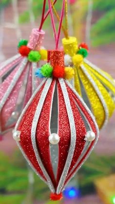 an ornament hanging from a string with colorful decorations on it's side