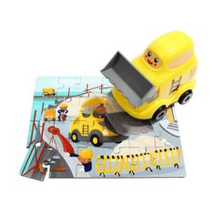 a yellow toy truck is on top of a puzzle