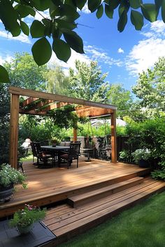 A backyard wooden deck with a pergola, outdoor dining table, chairs, and surrounded by lush greenery under a bright blue sky with scattered clouds. Diy Deck Ideas, Deck On A Budget, Backyard Deck Ideas, Outdoor Patio Ideas Backyards, Backyard Swings, Living Room Loft, Decks Backyard, Diy Deck, Backyard Deck