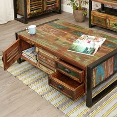 a coffee table made out of wood with drawers on each side and an open drawer in the middle