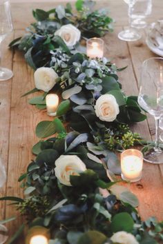 a long table with candles and flowers on it