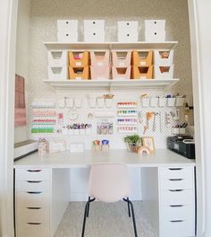 a white desk topped with lots of drawers and bins filled with crafting supplies