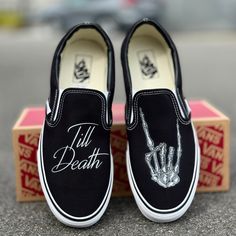 Till Death customized Black/White Vans Slip Ons with the rocker hand.These Vans are perfect for a wedding gift for a bride and groom. Custom Made-to-Order shoes. Looking for these in white? Grab them here: https://bit.ly/48jAKLm We buy each pair of blank shoes BRAND NEW from the Vans retail store. The ink is permanent and will never come off. Made in the USA. This price includes everything: shoes, artwork, and shipping. Please message us with any questions!Sizes listed are in US sizing scale. If Black Wedding In The Woods, All Black Groom Attire Casual, Halloween Wedding Ideas Receptions, Matching Wedding Shoes Bride And Groom, Halloween Wedding Ideas Diy, Gothic Outdoor Wedding, Wedding Ideas Dark, Friday The 13th Wedding, Classy Halloween Wedding