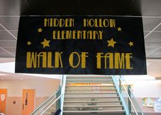 a sign that says hidden hollow elementary walk of fame hanging from the ceiling above some stairs