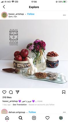 an instagram with flowers and other items on the table, including apples in a glass vase