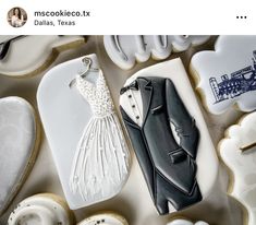 cookies decorated like wedding gown and tuxedo are on display in front of the camera