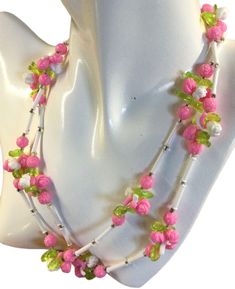 Charming 1950's flower and tube shaped lucite bead single strand necklace.  Unsigned.  Shown doubled but is a single strand with no closure, just slip over your head.  Smaller beads giving the necklace a more delicate, demure appearance.  Pink flowers, green leaves and white tube beads.   In very very good condition.  36" long.  We welcome your inquiries. White Tube, Flowers Green, Tube Beads, Strand Necklace, White Flower, Beaded Chain, Chain Styles, Green Leaves, White Flowers