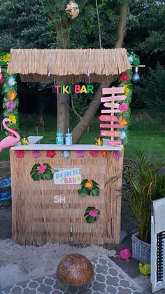 a tiki bar decorated with flowers and decorations