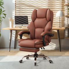 a brown leather office chair sitting in front of a desk with a laptop on it