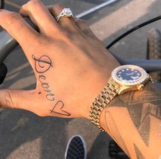 a person with a wrist tattoo on their left hand