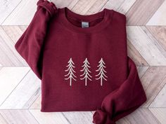 a red sweater with white trees on it