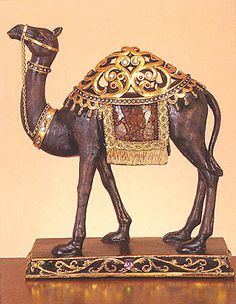 a figurine of a camel with a saddle on its back