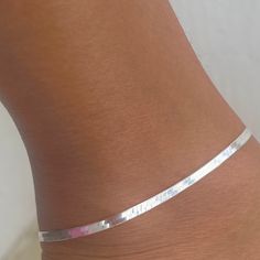 Experience the exquisite elegance and style of our meticulously crafted Herringbone Link Anklet. Made in Italy and handcrafted with precision, this anklet exudes sophistication and charm, elevating any ensemble with its luxurious luster and premium 925 sterling silver material. -Herringbone Link Anklet -925 Sterling Silver -Width: 3mm -Available in Size: 10". - Hypoallergic and Nickel Free - Tarnish Free and Water Resistant Silver Minimalist Anklets For Gift, White Sterling Silver Anklets As Gift, Minimalist Silver Flexible Bracelet, Minimalist Flexible Silver Bracelet, Adjustable Sterling Silver Anklets For Wedding, Minimalist Sterling Silver Anklets In Silver, Silver Minimalist Anklets For Party, Adjustable Sterling Silver Wedding Anklets, Handmade Silver Anklets As A Gift