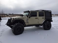 a white jeep parked in the snow