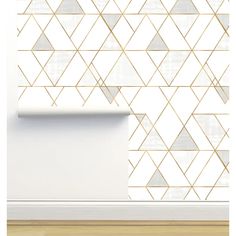 a white wall with gold triangles on it