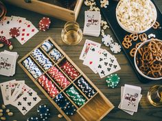 the table is full of cards, chips, and other items to play in this game