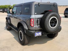 a black jeep parked in a parking lot