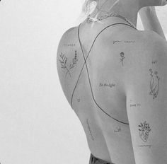 a woman with tattoos on her back