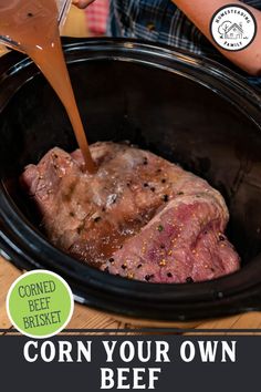 a person pouring sauce on top of a meat in a slow cooker with the words corn your own beef