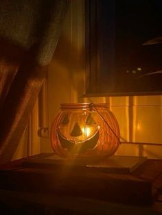 a pumpkin shaped lantern sitting on top of a table