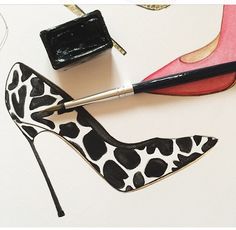 a pair of black and white high heeled shoes next to a purse on top of a table