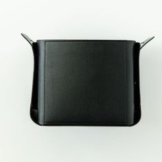 an empty black leather case on a white background