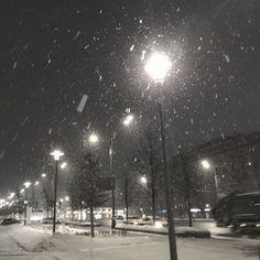 a snowy night with street lights and cars