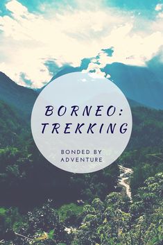 the words, borneo trekking are in front of a mountain range with trees and clouds