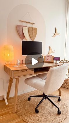 a desk with a computer on top of it in a room next to a window