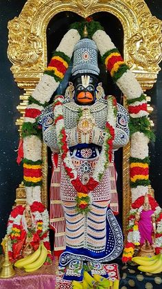 the statue is decorated with flowers and garlands