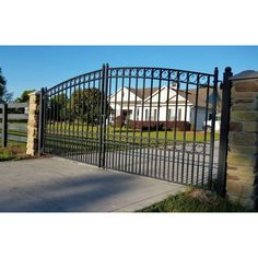 an iron gate is shown in front of a house