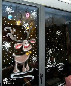 an image of a glass window decorated with reindeers and snowflakes on it